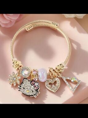 Gold Tone Hello Kitty Charm Bracelet with Pink Accents
